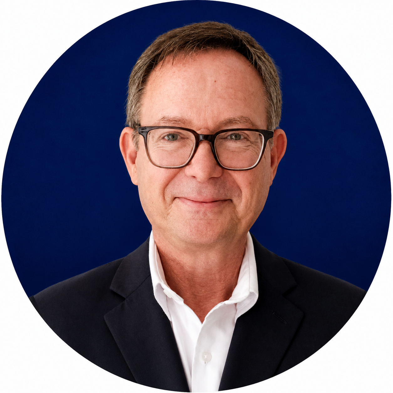 Head-and-shoulders portrait of a bespectacled man in a dark suit and white shirt against a navy circular background