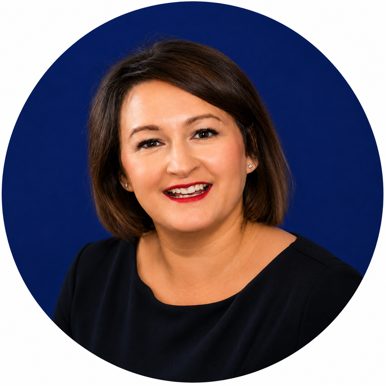 Smiling woman with short brown hair and red lipstick, wearing a black top against a dark blue background